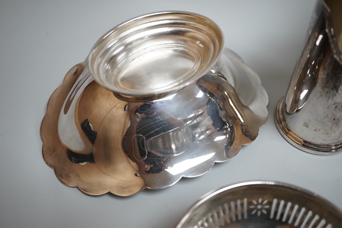 A modern silver oval pedestal sweetmeat bowl, by Mappin & Webb, Birmingham, 1987, 15.8cm, together with a small silver bottle holder, a silver mounted vase and a sterling two handled nut dish.